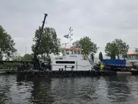 Multicat multipurpose vessel with hydraulic crane & spud pole legs